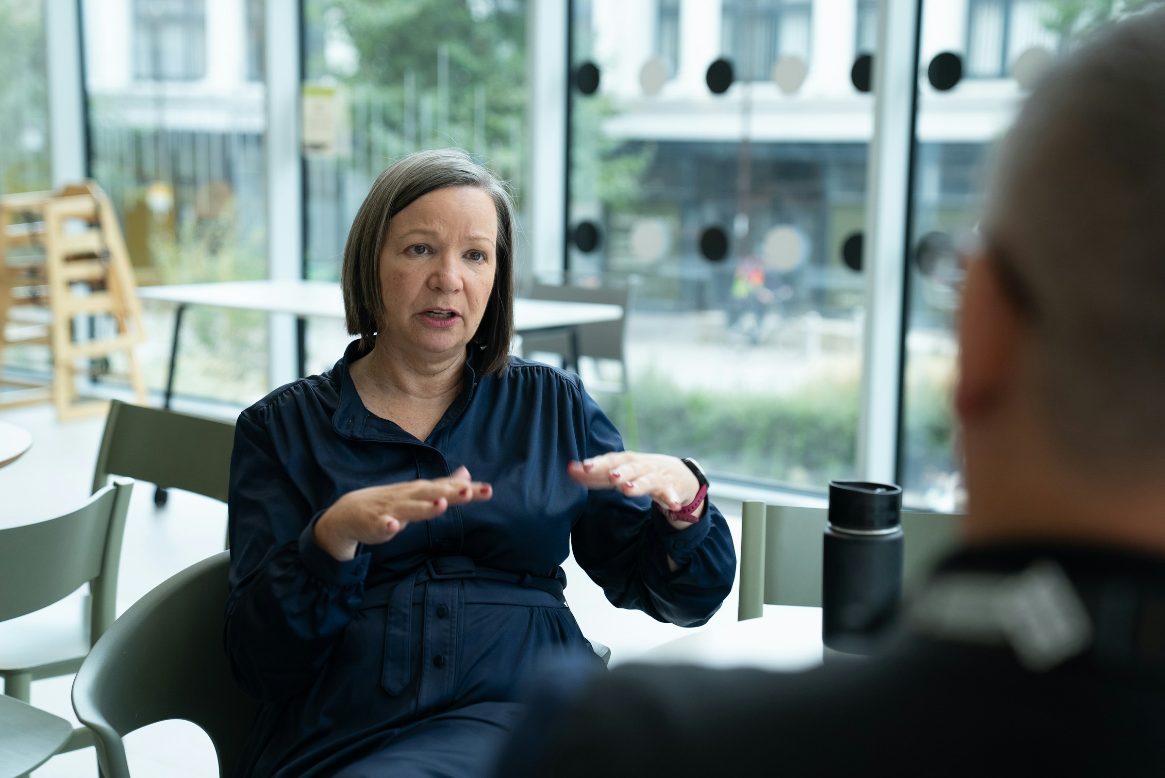 A woman explaining something to a colleague across a table